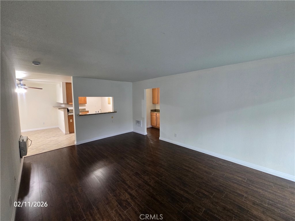 1345 Cabrillo Park, Unit R03 Santa Ana, CA 92701 - Photo 2 of 21 a view of empty room with wooden floor