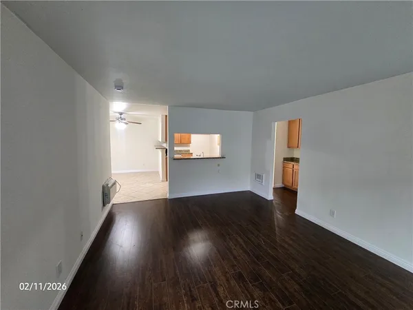 a view of wooden floor and windows in an empty room