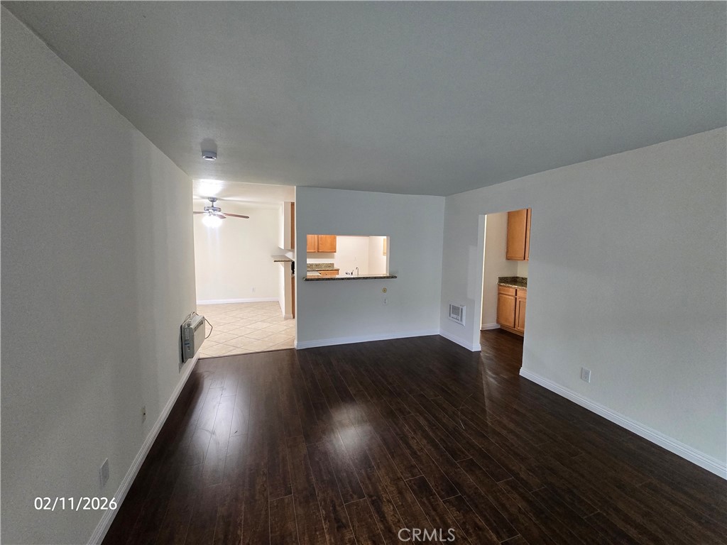 1345 Cabrillo Park, Unit R03 Santa Ana, CA 92701 - Photo 3 of 21 a view of wooden floor and windows in an empty room