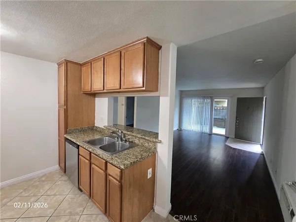 a kitchen with granite countertop a sink stove and cabinets