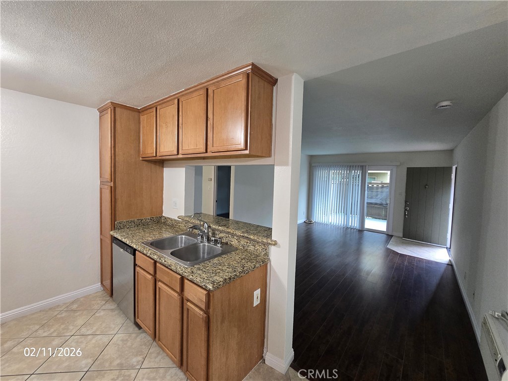 1345 Cabrillo Park, Unit R03 Santa Ana, CA 92701 - Photo 6 of 21 a kitchen with granite countertop a sink stove and cabinets