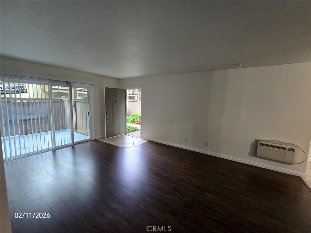 1345 Cabrillo Park, Unit R03 Santa Ana, CA 92701 - Photo 9 of 21 an empty room with wooden floor and windows