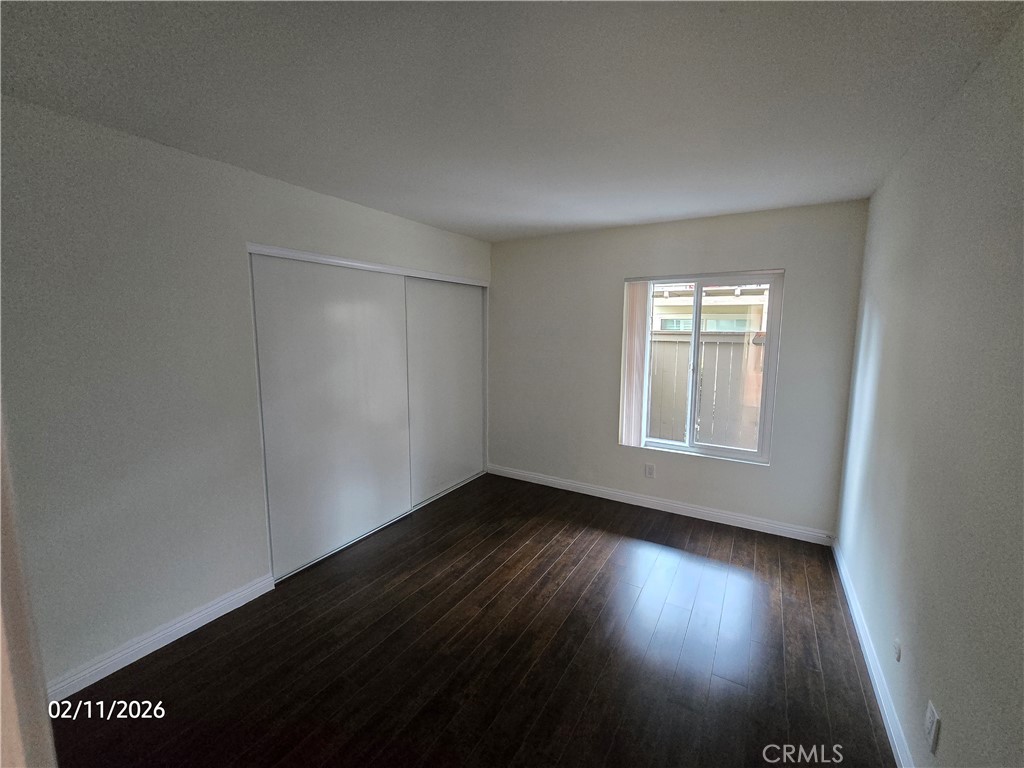 1345 Cabrillo Park, Unit R03 Santa Ana, CA 92701 - Photo 10 of 21 an empty room with wooden floor and windows