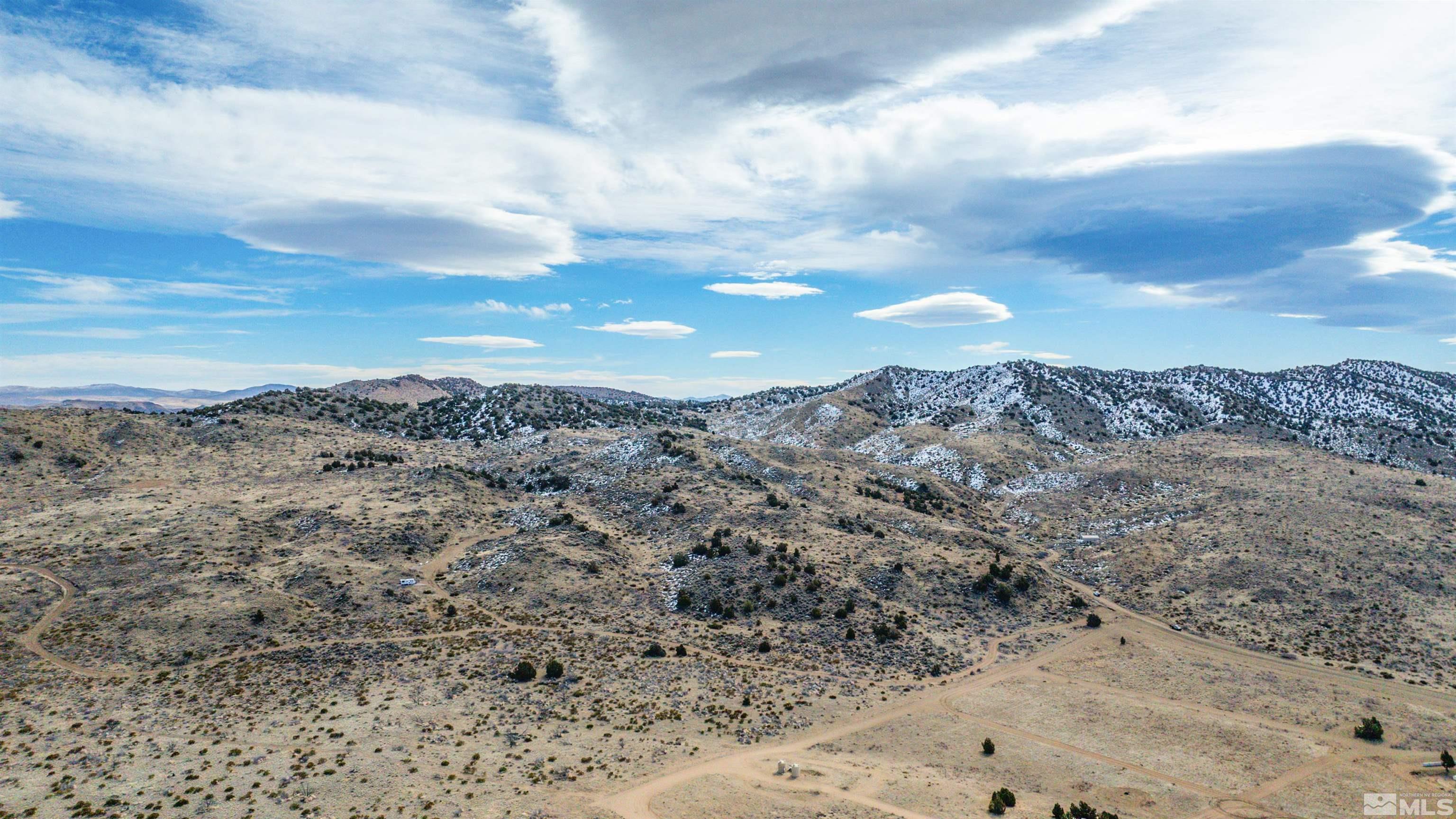 125 Oregon Hills Lane Reno, NV 89506 - Photo 6 of 32 a view of a dry yard with mountains in the background