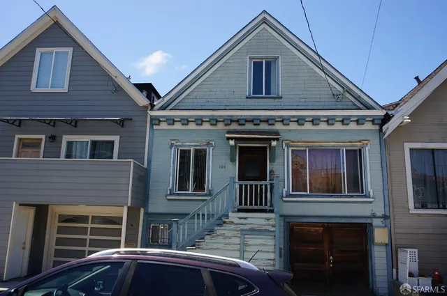 a front view of a house with a parking space