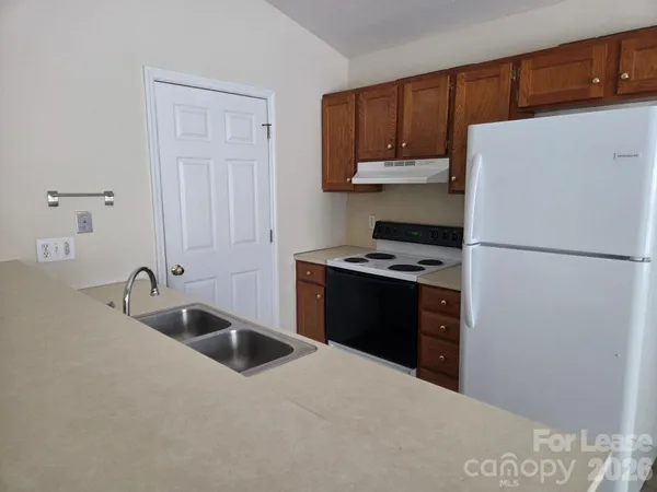 a kitchen with a refrigerator and a sink