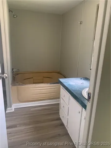 a view of a kitchen with a sink wooden cabinets and window