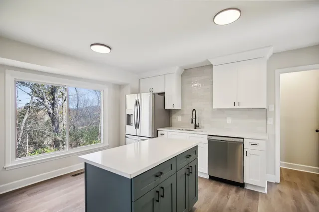 a kitchen with a sink stove and refrigerator