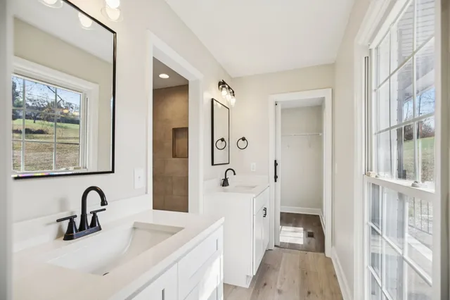 a bathroom with a double vanity sink mirror and double