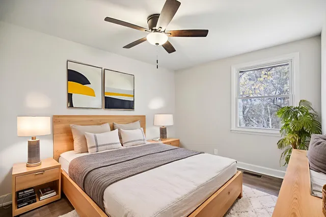 a bedroom with a bed and a painting on the wall