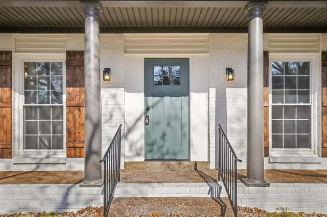 a front view of a house with a garden