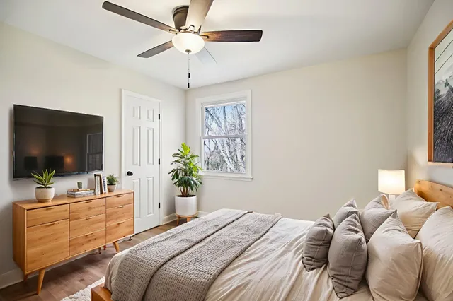 a bedroom with a bed and a flat screen tv