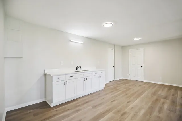 a view of a kitchen with white cabinets