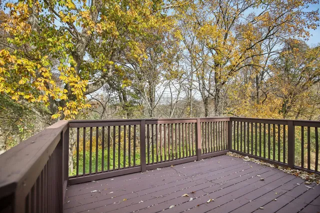a balcony with wooden floor and fence