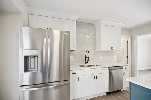 a white refrigerator freezer sitting in a kitchen