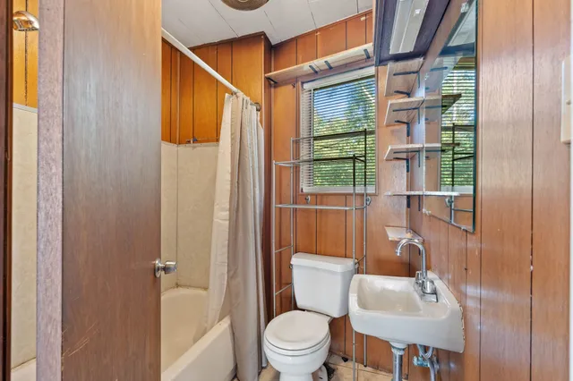 a bathroom with a toilet a sink and a shower