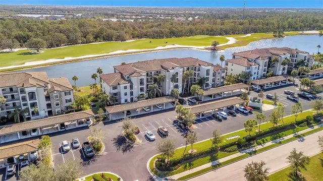an aerial view of residential houses with outdoor space and swimming pool