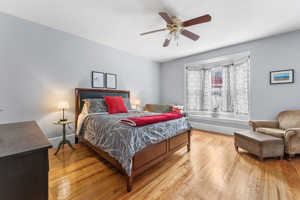 322 Highland Street Worcester, MA 01602 - Photo 12 of 32 a bedroom with a bed and a couch