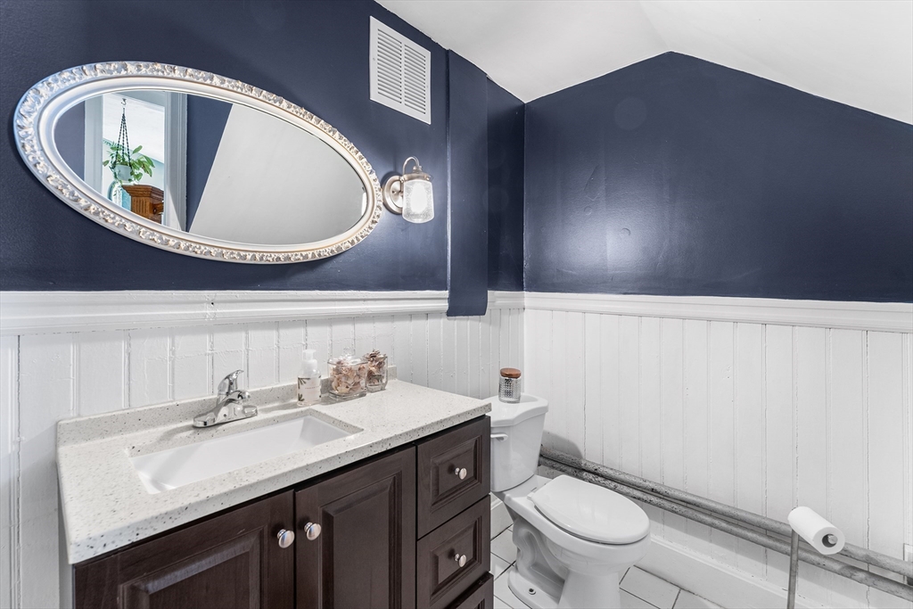 322 Highland Street Worcester, MA 01602 - Photo 12 of 29 a bathroom with a toilet sink and mirror