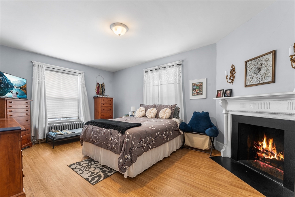 322 Highland Street Worcester, MA 01602 - Photo 14 of 32 a bedroom with a bed and a fireplace