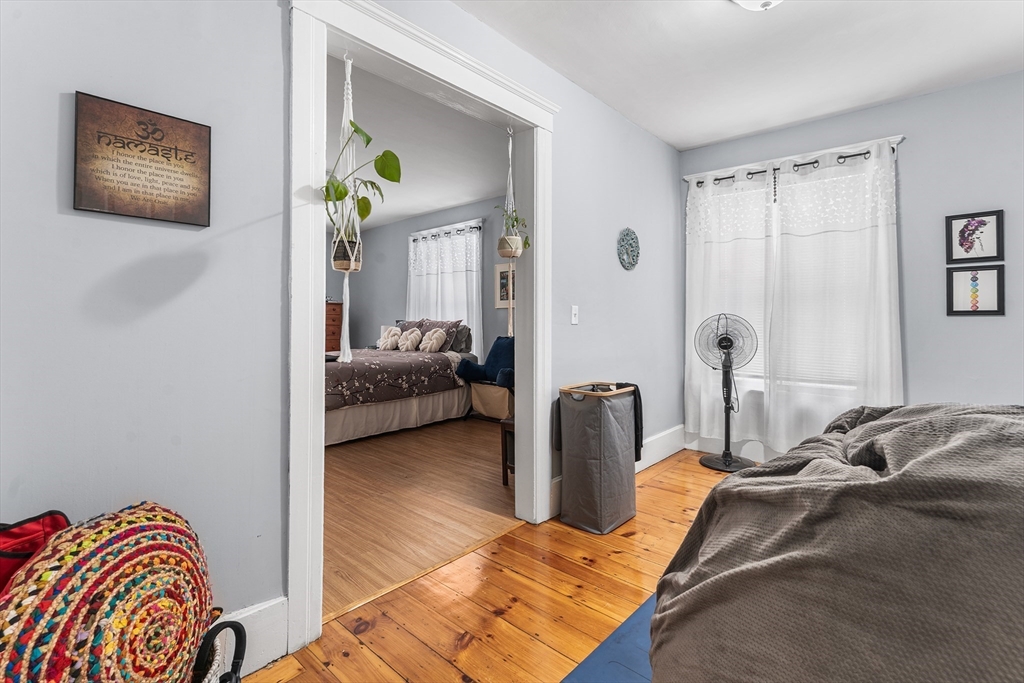 322 Highland Street Worcester, MA 01602 - Photo 17 of 29 a bedroom with a bed and a painting on the wall