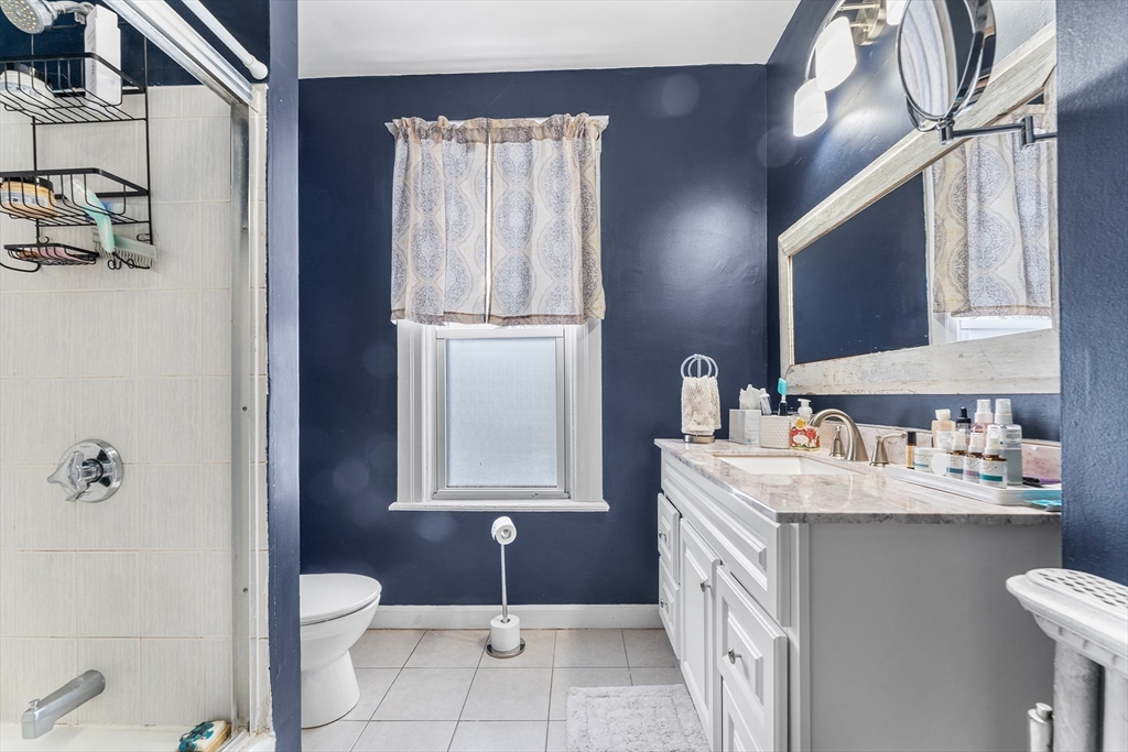 322 Highland Street Worcester, MA 01602 - Photo 20 of 29 a bathroom with a sink a toilet and mirror