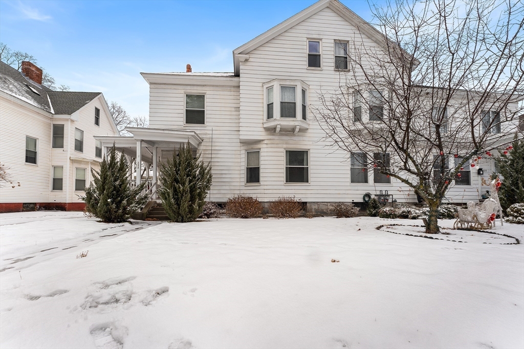 322 Highland Street Worcester, MA 01602 - Photo 2 of 29 a view of a white house with a snow
