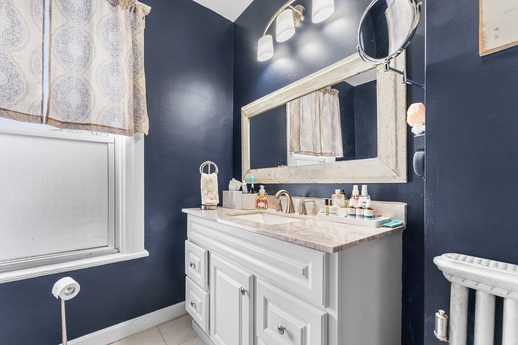 322 Highland Street Worcester, MA 01602 - Photo 21 of 29 a bathroom with a sink vanity and a mirror