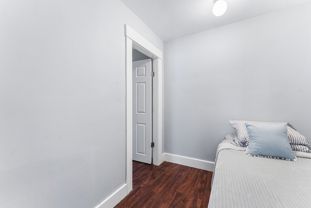 322 Highland Street Worcester, MA 01602 - Photo 23 of 32 a room with a bed and wooden floor