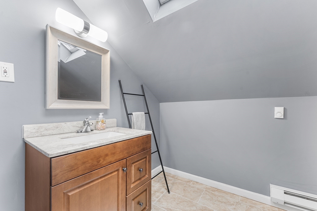322 Highland Street Worcester, MA 01602 - Photo 25 of 32 a bathroom with a sink and a mirror