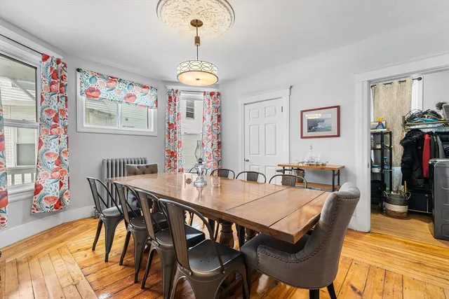 a view of a dining room with furniture wooden floor and chandelier