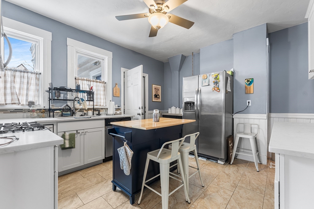 322 Highland Street Worcester, MA 01602 - Photo 7 of 32 a kitchen with cabinets a sink stainless steel appliances and window