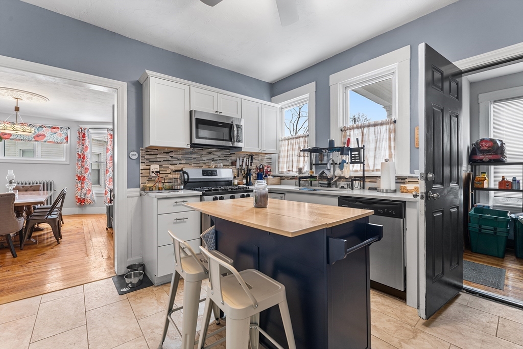 322 Highland Street Worcester, MA 01602 - Photo 9 of 29 a kitchen with stainless steel appliances kitchen island granite countertop a sink stove and refrigerator