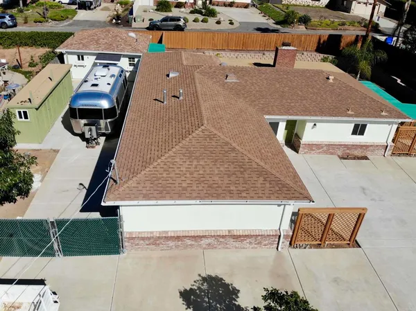 an aerial view of a house with a swimming pool