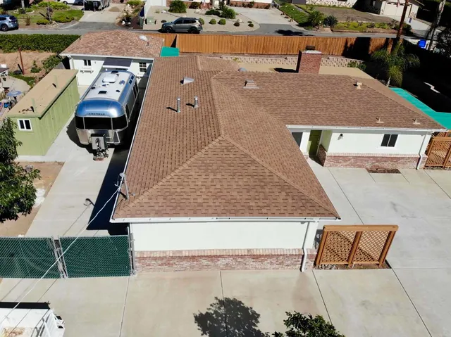 an aerial view of a house with a swimming pool
