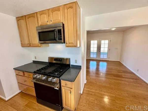 a kitchen with stainless steel appliances granite countertop a stove and a microwave