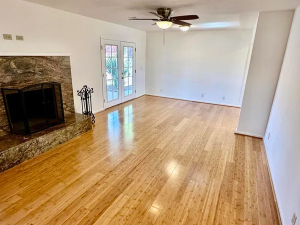wooden floor in an empty room with a fireplace