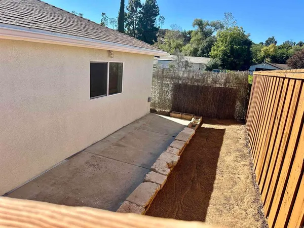 a view of a back yard of the house with a street