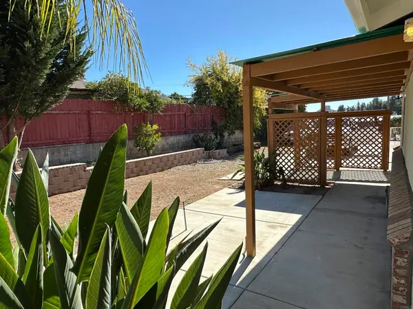 a view of a house with a wooden deck