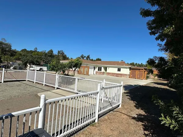 a view of a house with a outdoor space and sitting area