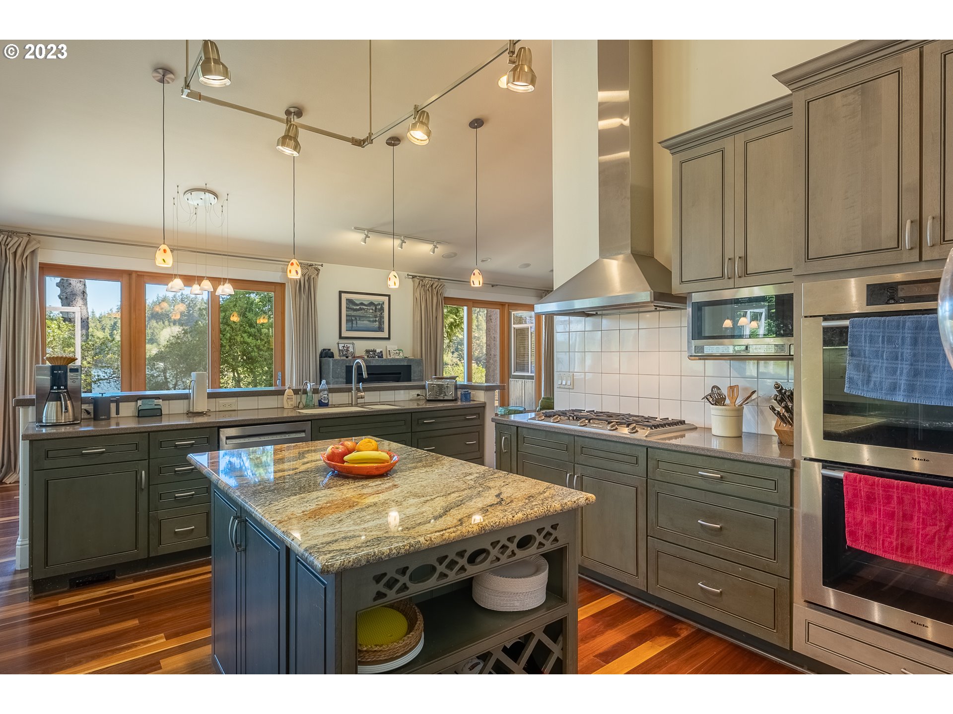 83917 Cloud 9 Road Florence, OR 97439 - Photo 17 of 48 a kitchen with stainless steel appliances granite countertop a stove a sink dishwasher and cabinets with wooden floor