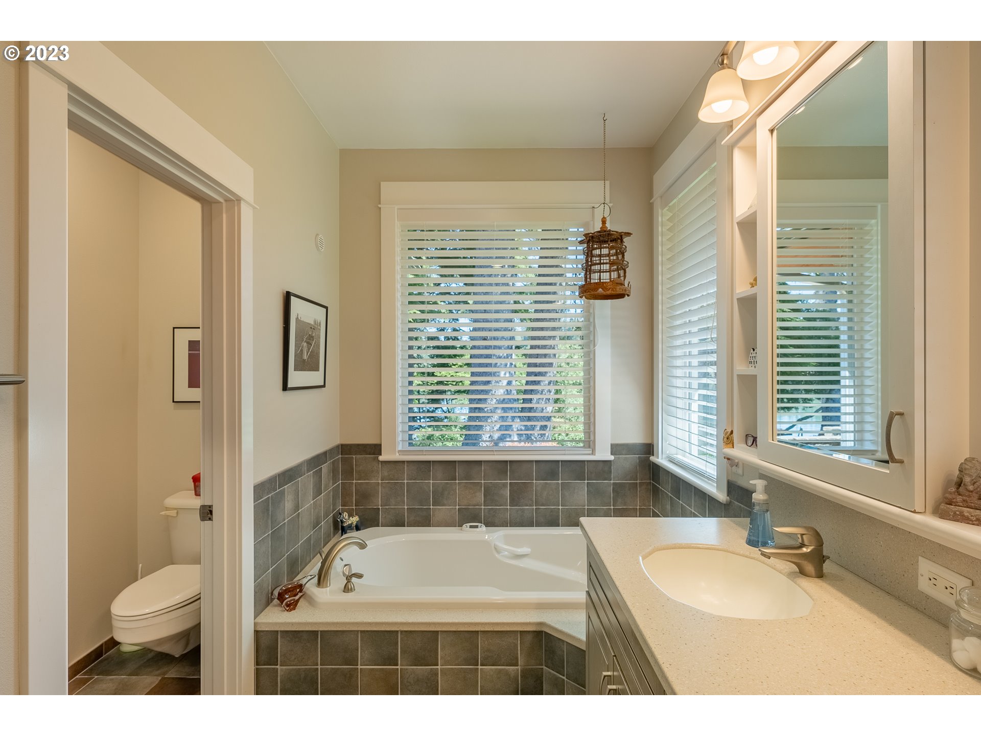 83917 Cloud 9 Road Florence, OR 97439 - Photo 26 of 48 a bathroom with a granite countertop tub a sink and a large mirror