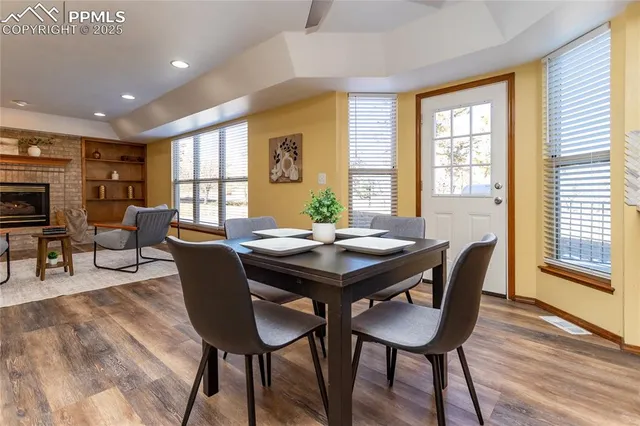 a view of a dining room with furniture and wooden floor