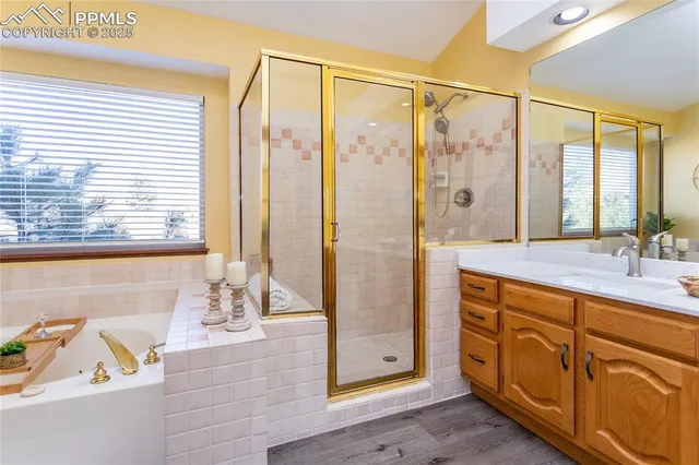 a bathroom with a tub sink and mirror