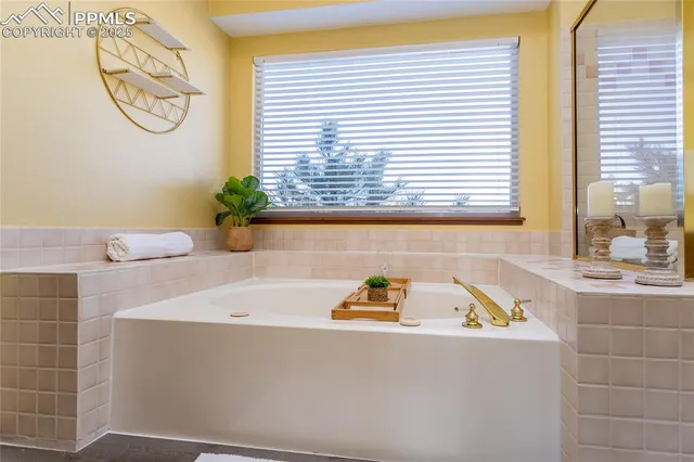 a bathroom with a bathtub a sink and a window