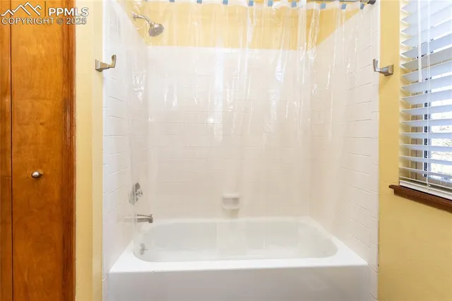 a bathroom with a shower curtain