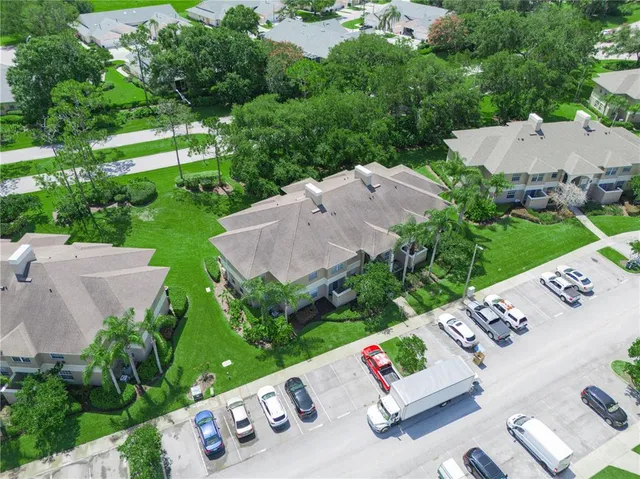 an aerial view of a house with garden space and street view