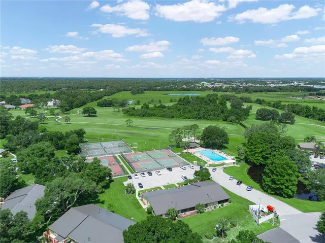 an aerial view of a house with swimming pool patio and outdoor seating