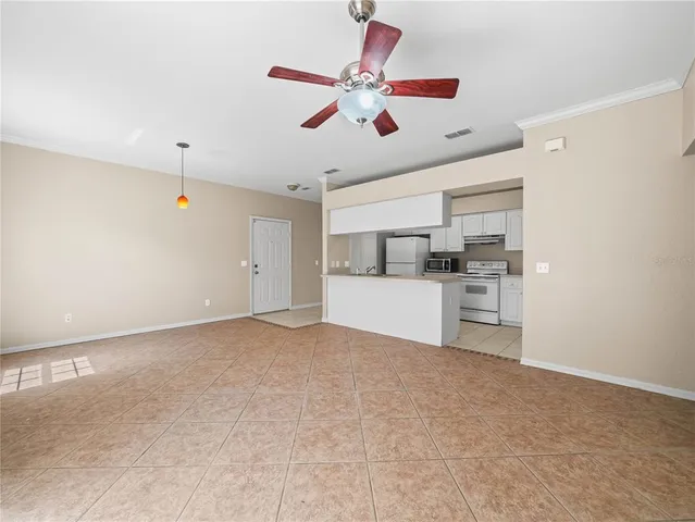 a kitchen with white cabinets and a refrigerator