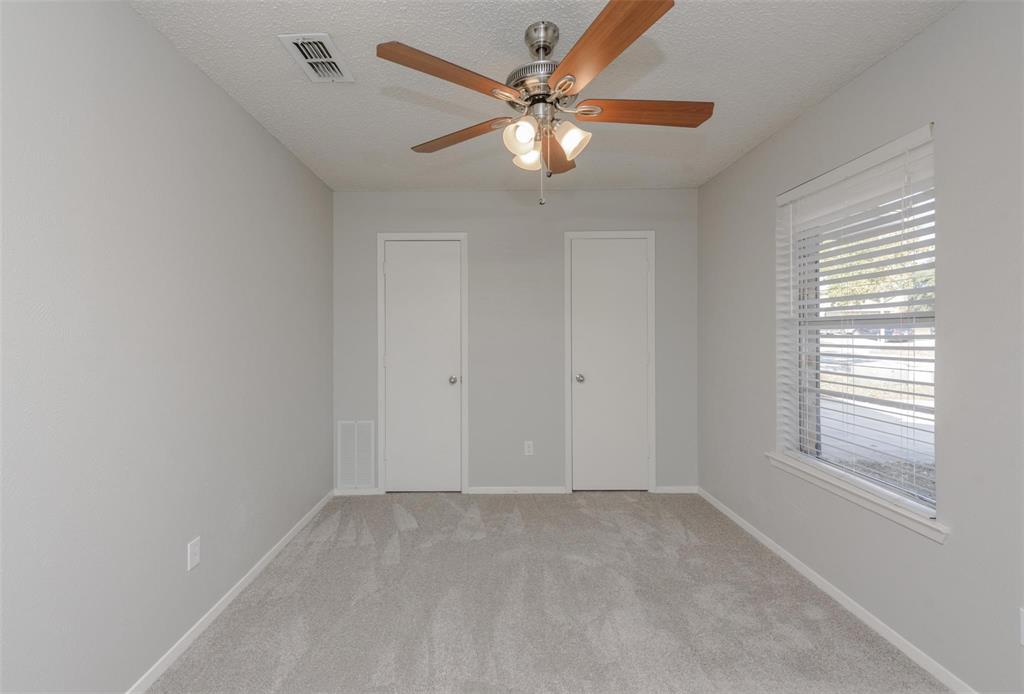 3609 Cooper Branch East Denton, TX 76209 - Photo 15 of 23 an empty room with a chandelier fan and windows